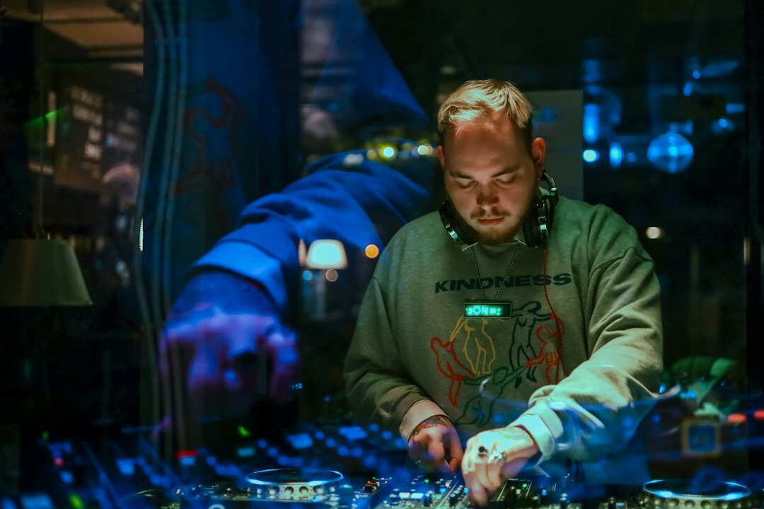 Sound engineer working on an audio mixing console during a broadcast